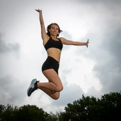 Frau springt hoch in Sportkleidung